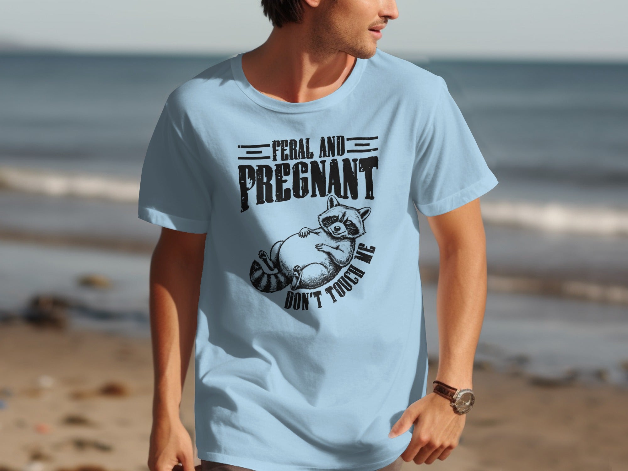 Light blue t-shirt with graphic: "Feral and Pregnant", a raccoon, "Don't Touch Me".
