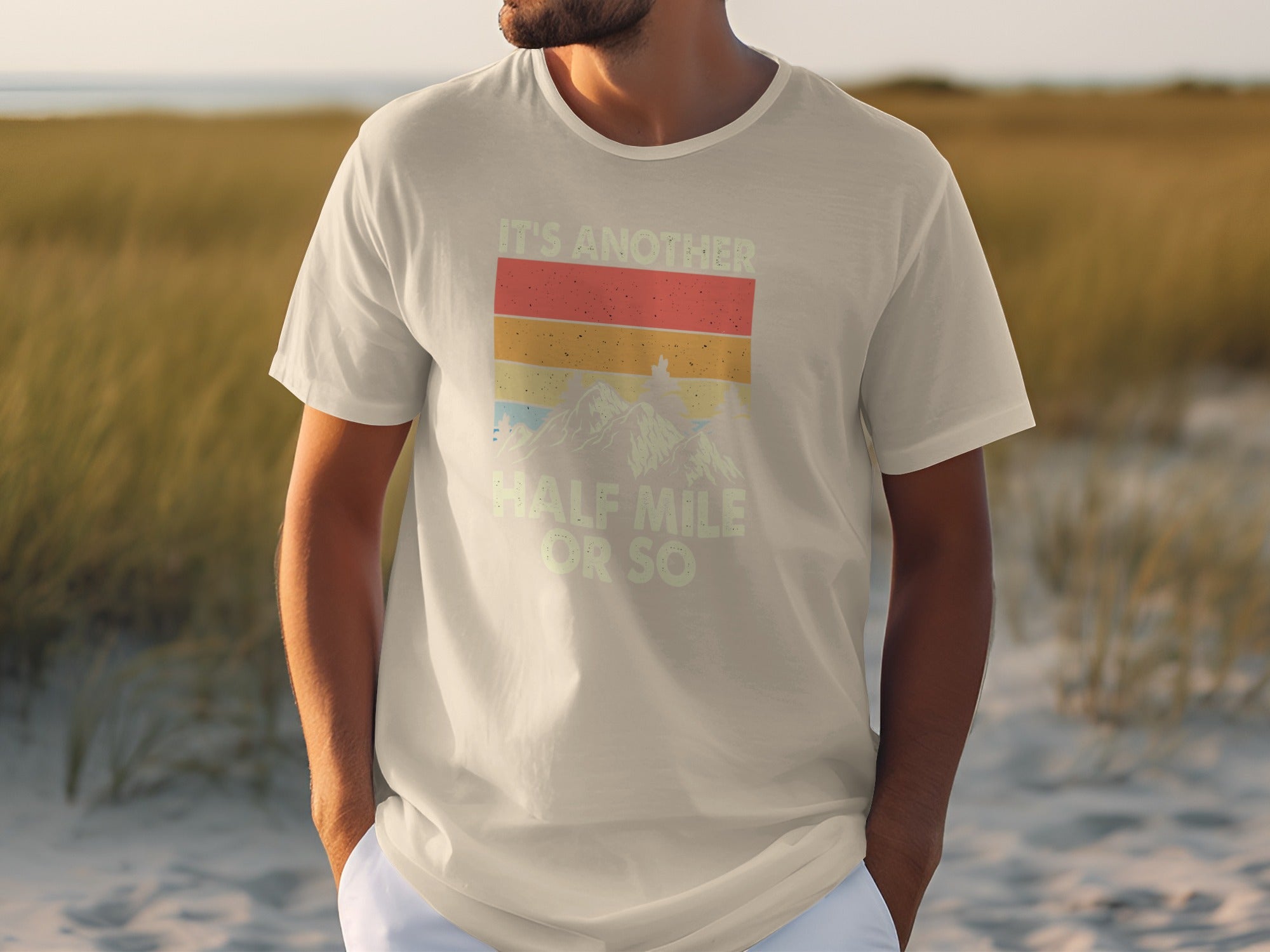 T-shirt with vintage sunset mountain graphic and "It's another half mile or so" text.
