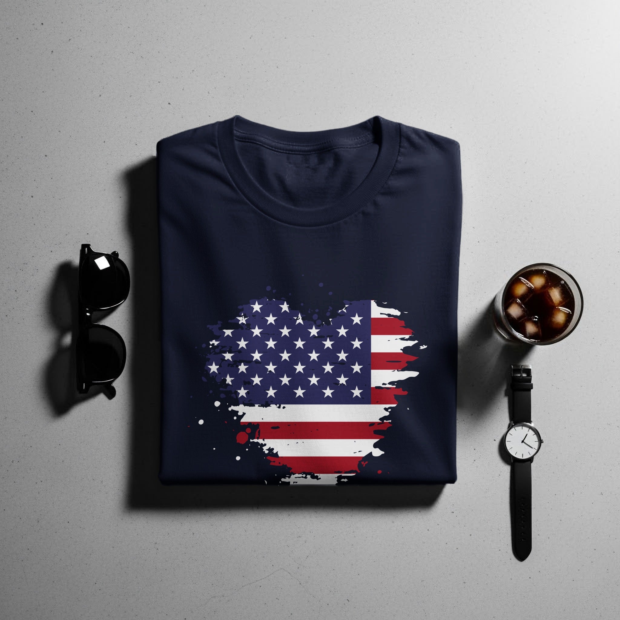 Navy t-shirt with distressed American flag graphic, sunglasses, cocktail, and watch.