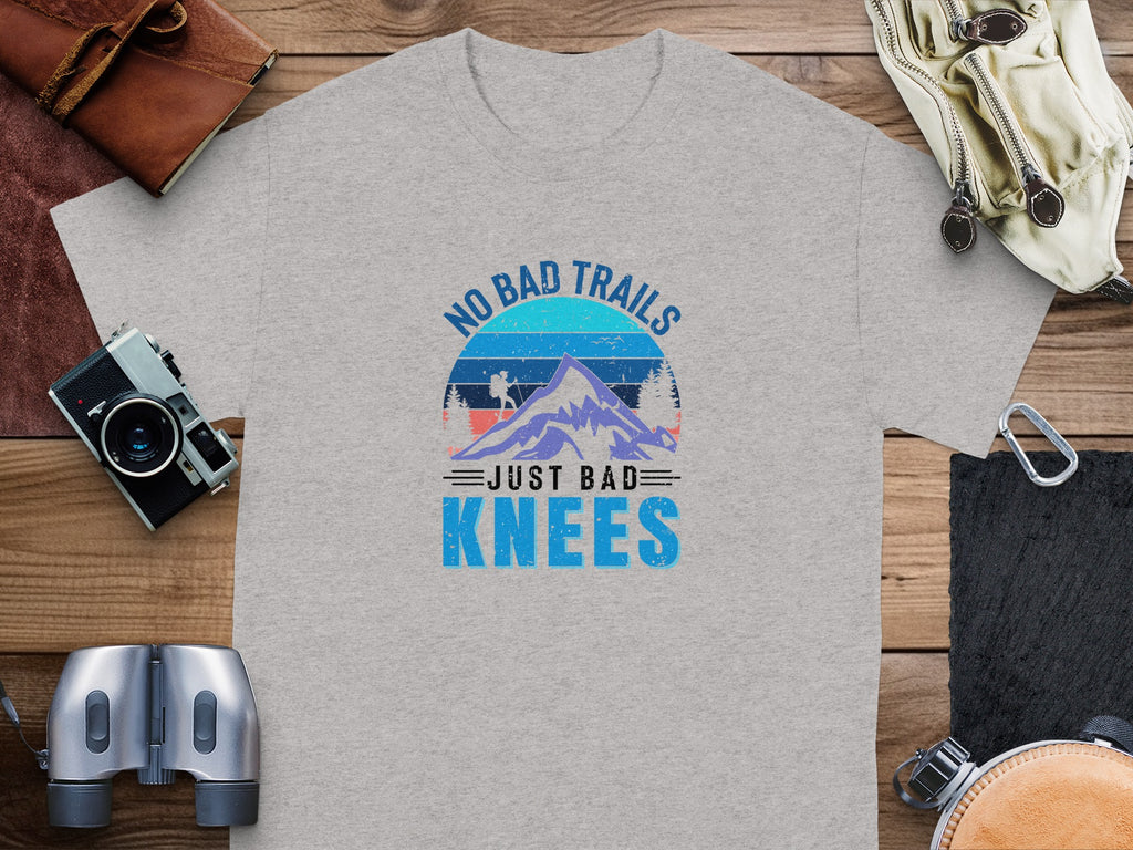 Grey t-shirt with "NO BAD TRAILS JUST BAD KNEES" graphic and mountain scene.