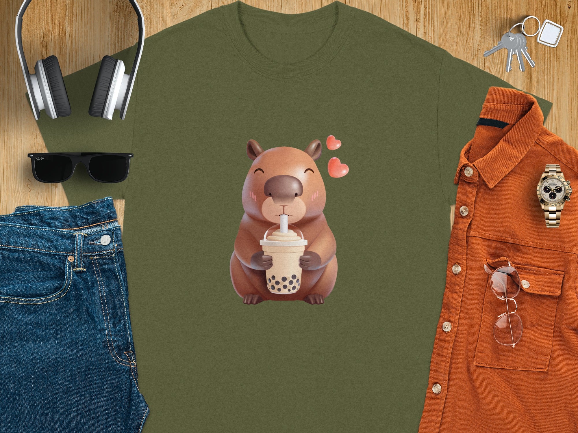 Green t-shirt with cartoon capybara holding a boba tea drink.