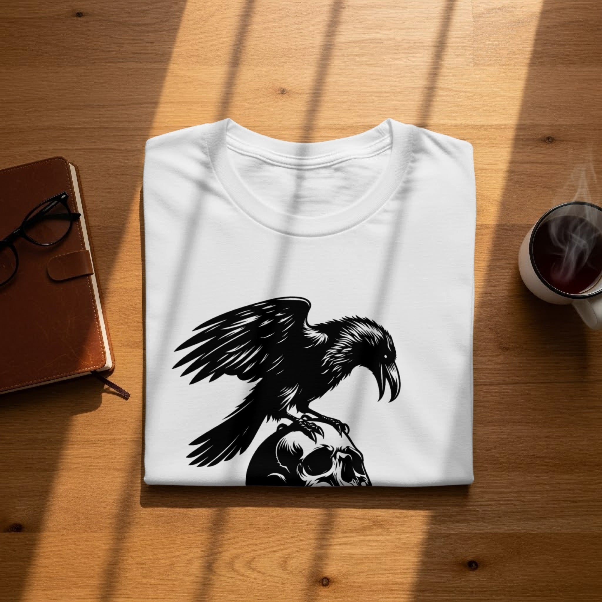 White t-shirt with black graphic of a crow perched on a skull.