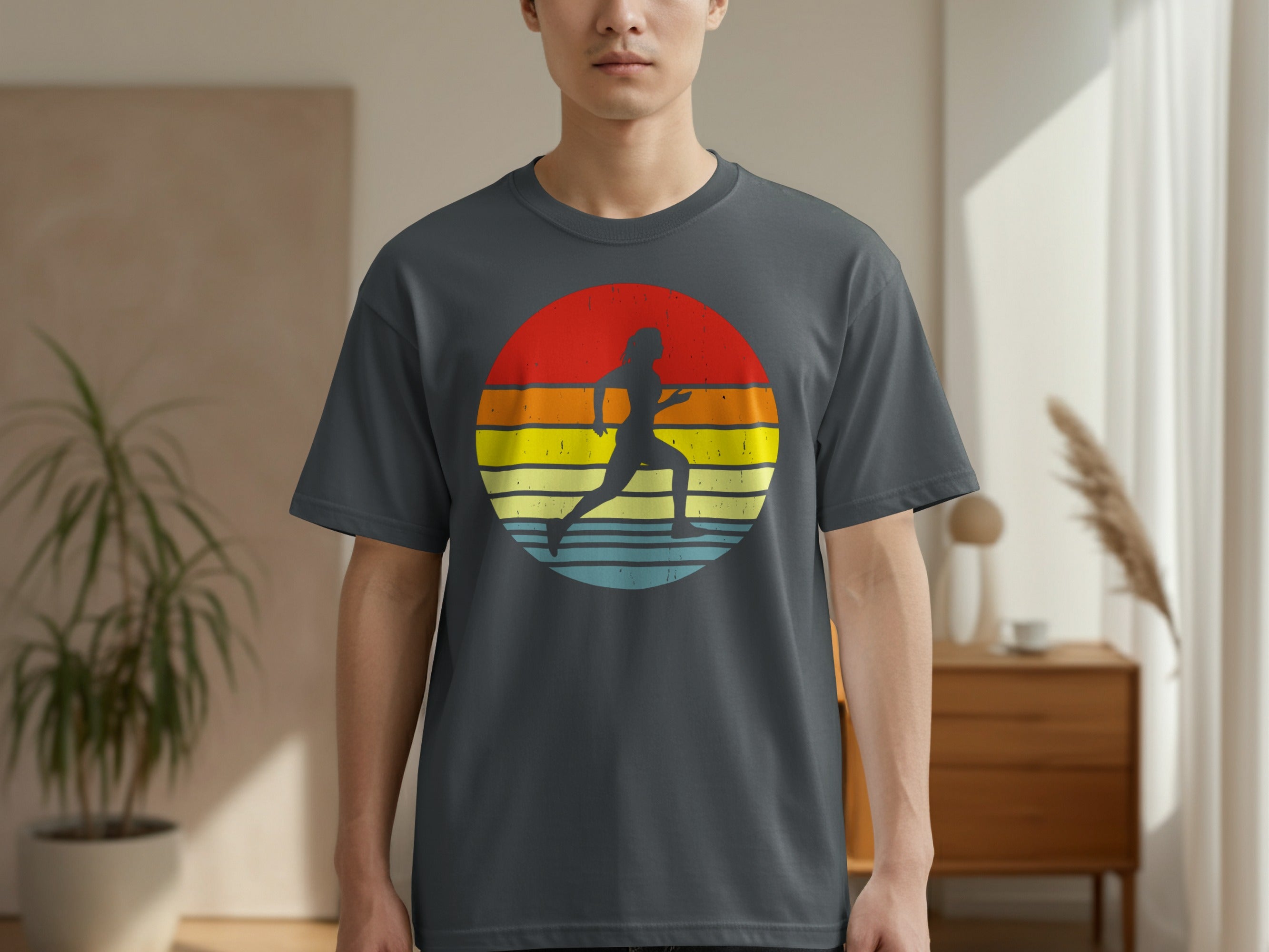 Silhouette of a runner against a circular, striped sunset design on a t-shirt.