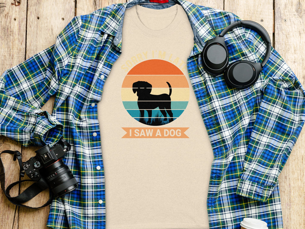 Beige t-shirt with black dog silhouette and text "Sorry I'm late I saw a dog".