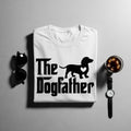 White t-shirt with "The Dogfather" text and dachshund silhouette with heart.