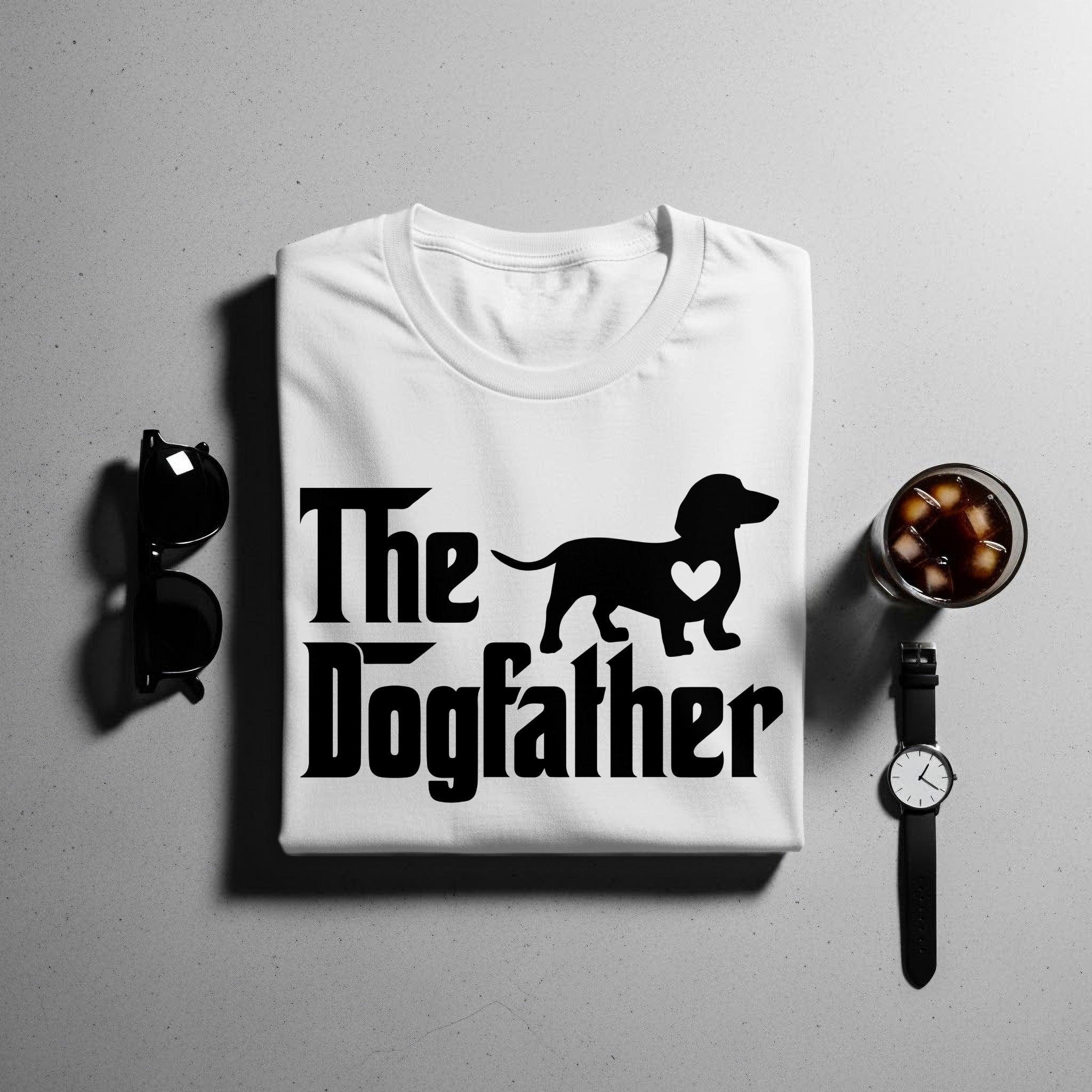 White t-shirt with "The Dogfather" text and dachshund silhouette with heart.