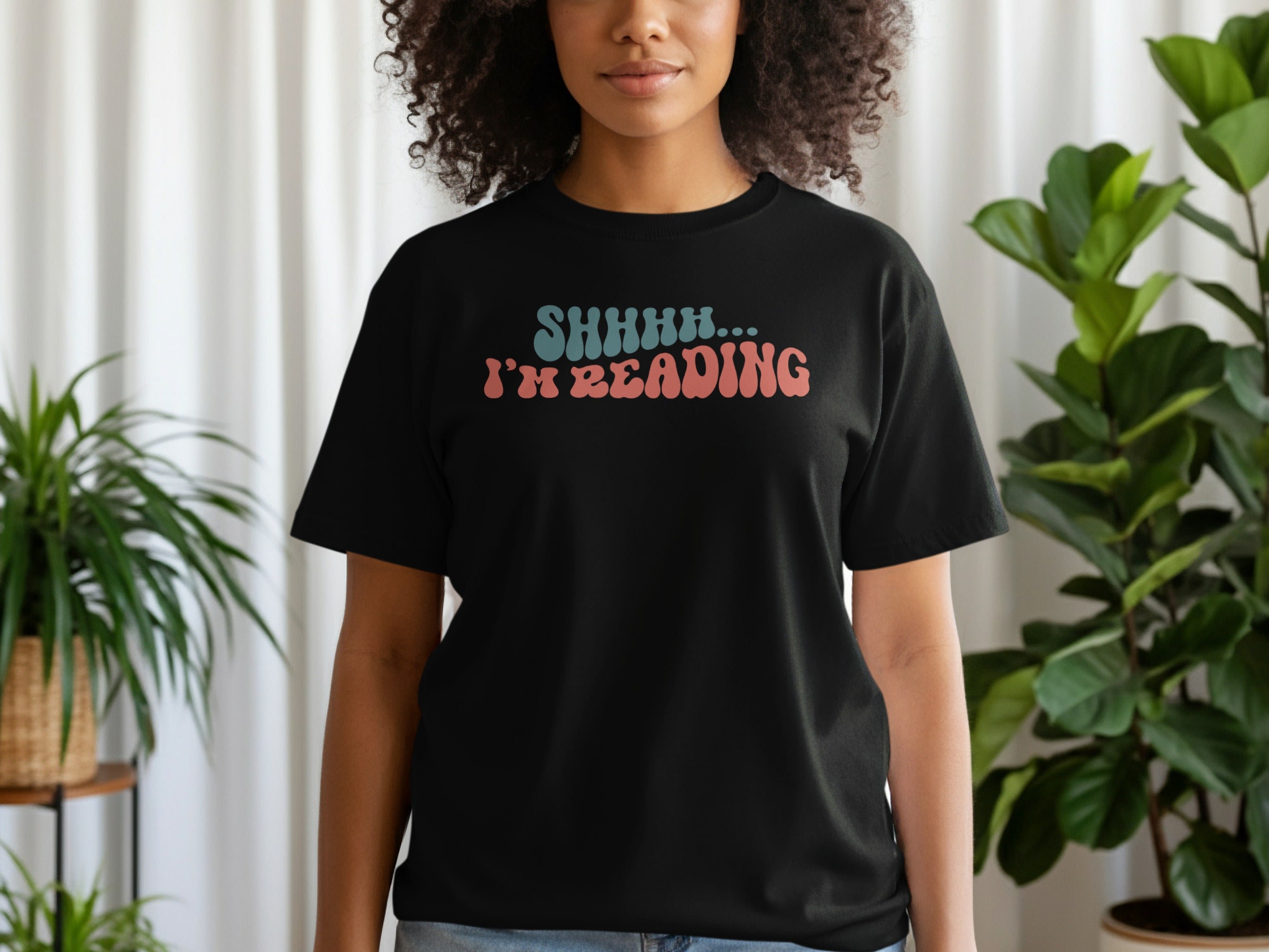 Black t-shirt with "SHHHH... I'M READING" text in groovy font.