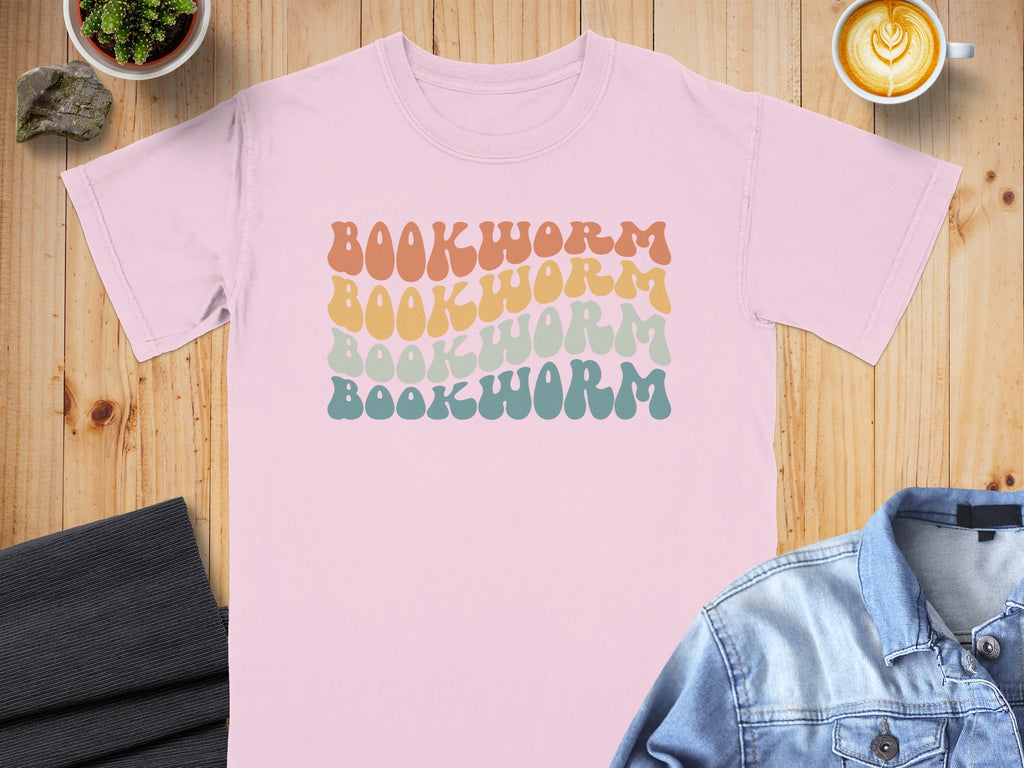 Pink t-shirt with stacked wavy text that says BOOKWORM in multiple colors