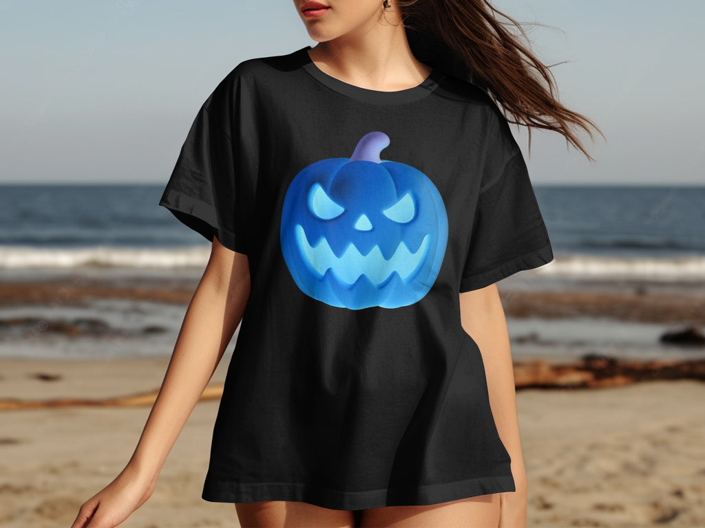 Black t-shirt with a glowing blue jack-o'-lantern graphic on a beach background.