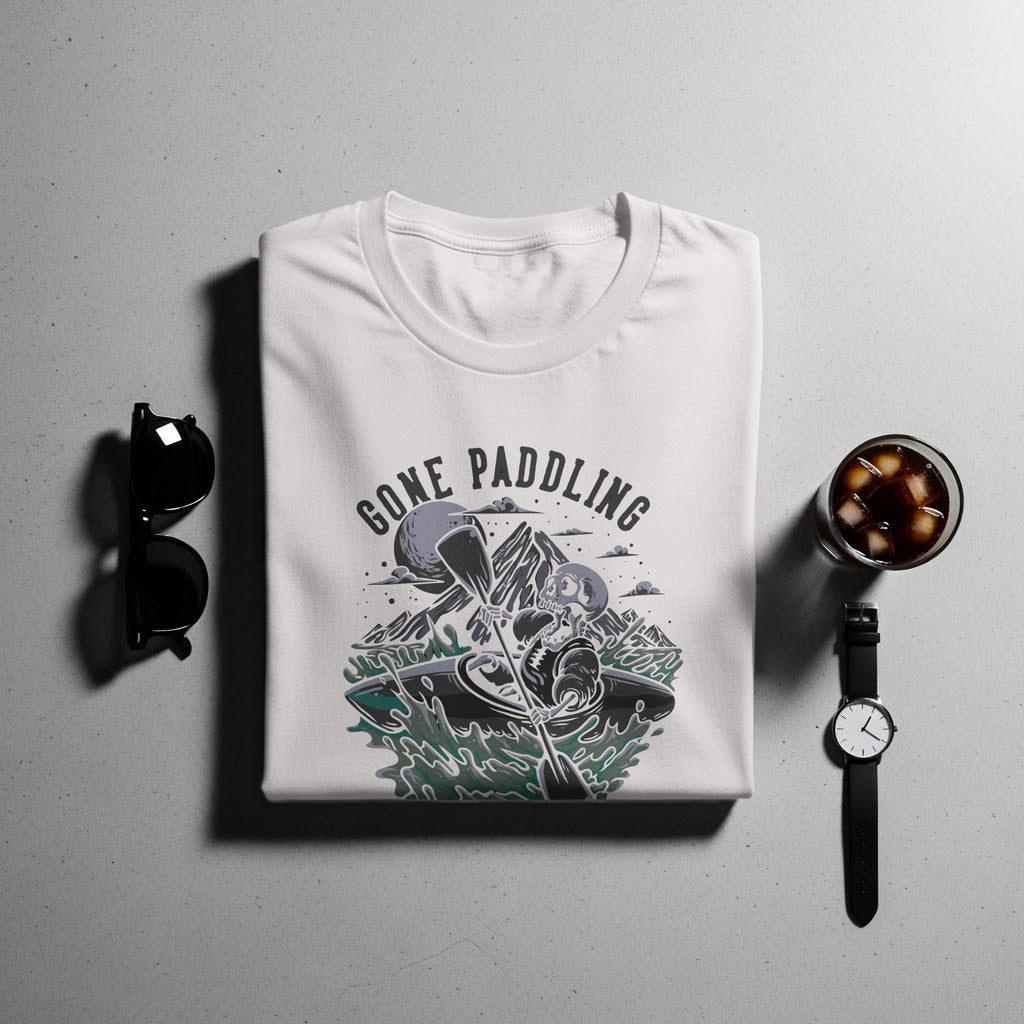 T-shirt with graphic of skeleton kayaking and text "GONE PADDLING".