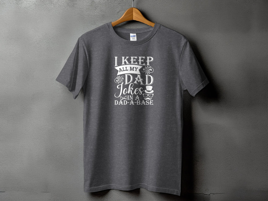 Dark gray t-shirt with "I keep all my dad jokes in a dad-a-base" text and graphics.