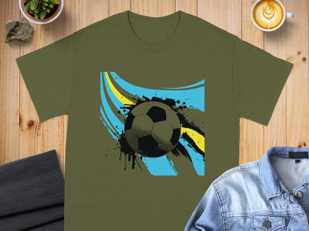 Olive green t-shirt with abstract soccer ball and paint splatter graphic.