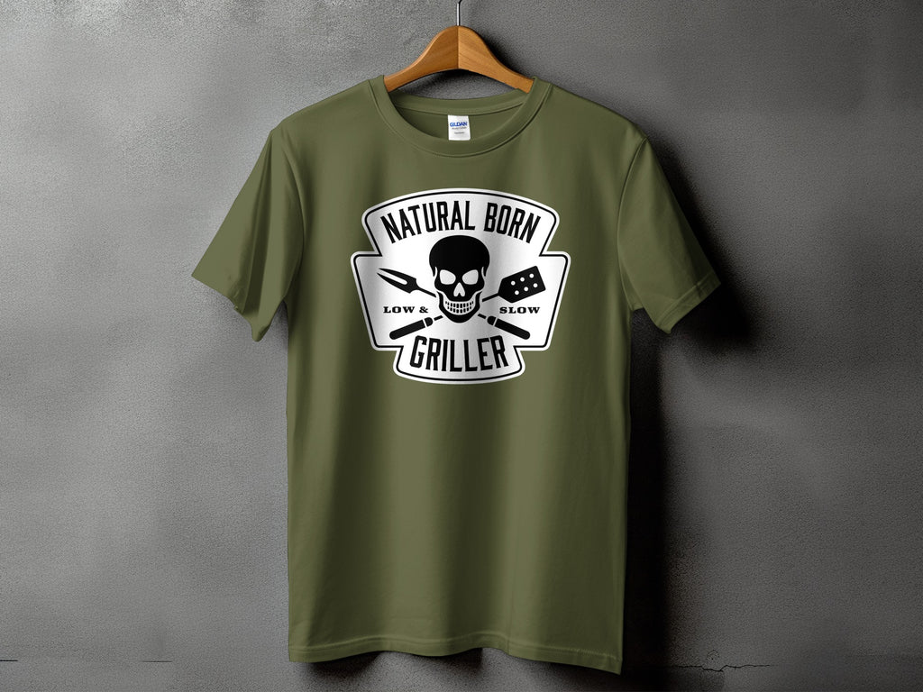 Olive green t-shirt with "Natural Born Griller" skull and barbecue tools graphic.
