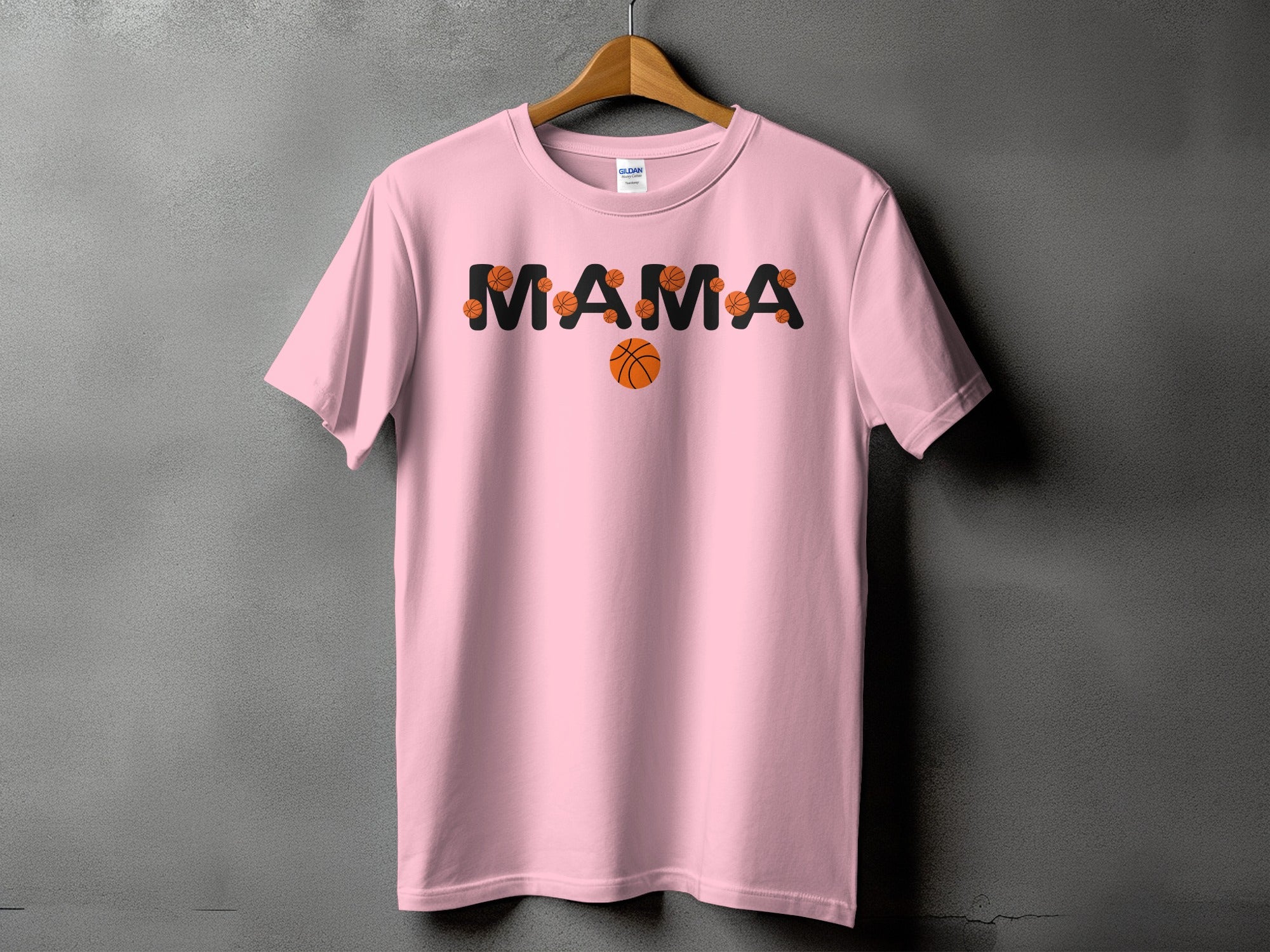 Pink t-shirt with "MAMA" text design featuring basketballs.