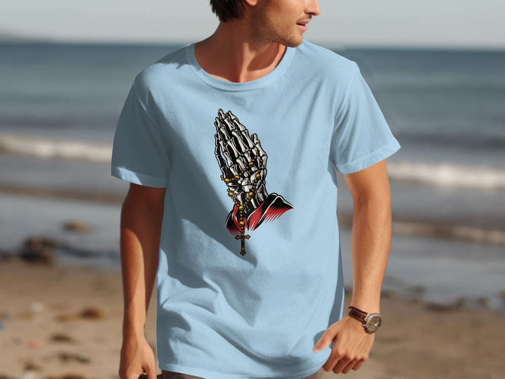 Light blue t-shirt with skeleton praying hands and cross graphic.