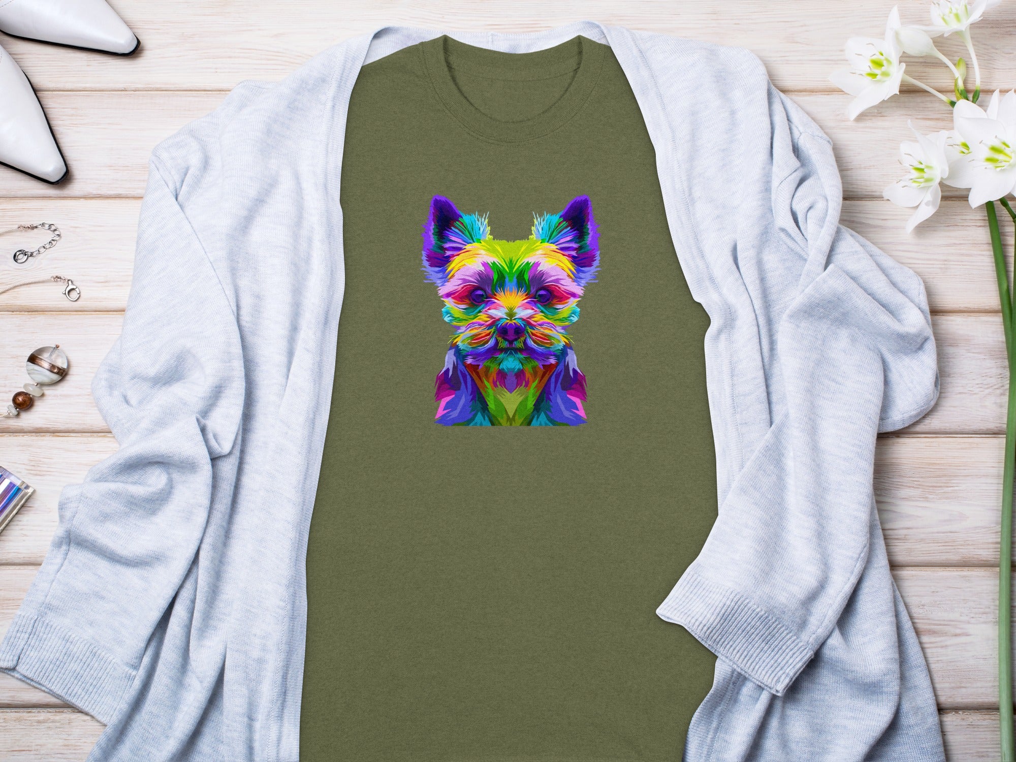 Green t-shirt with colorful abstract dog face graphic.