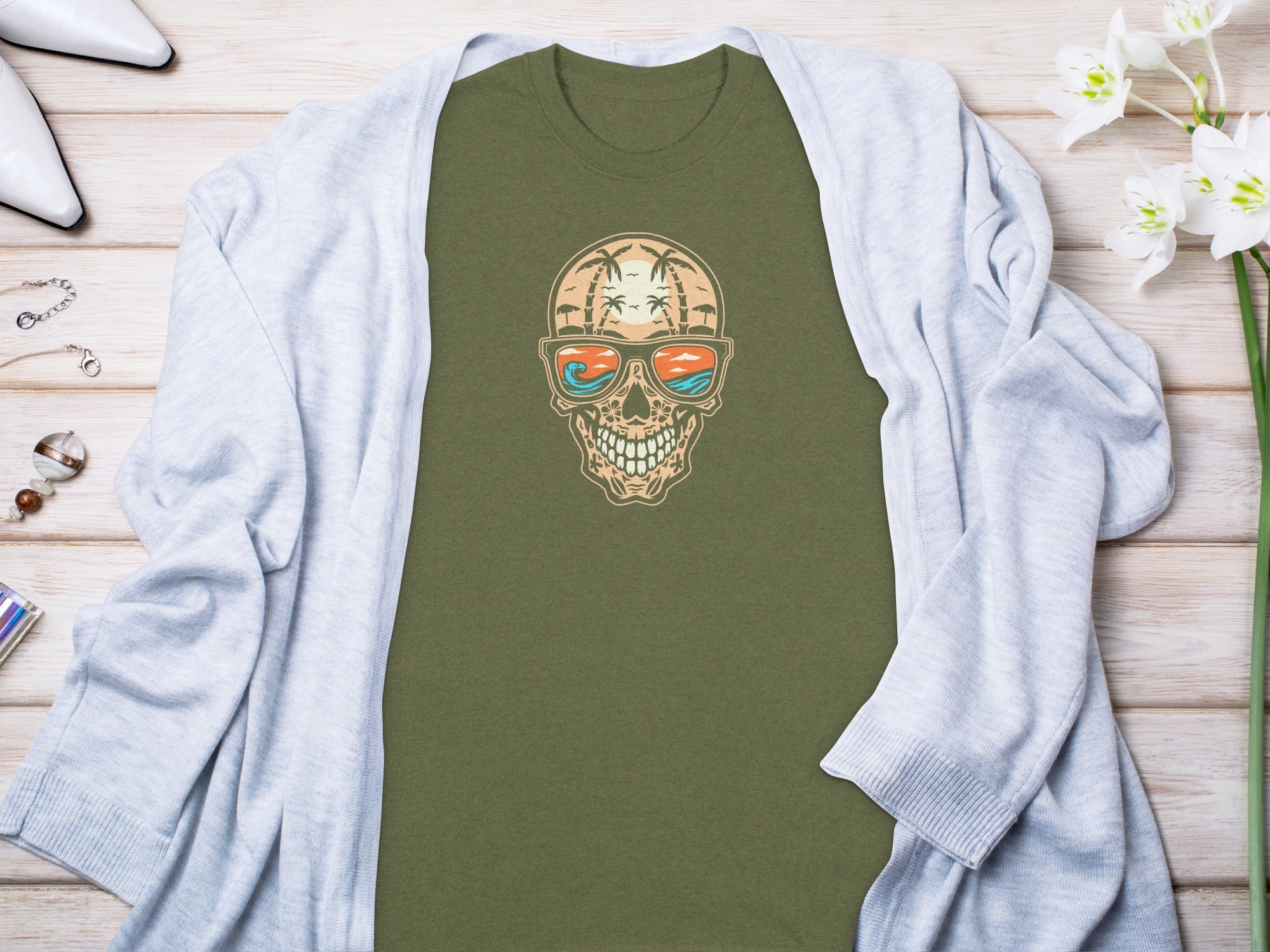 Olive t-shirt with a skull graphic wearing sunglasses with a beach scene.
