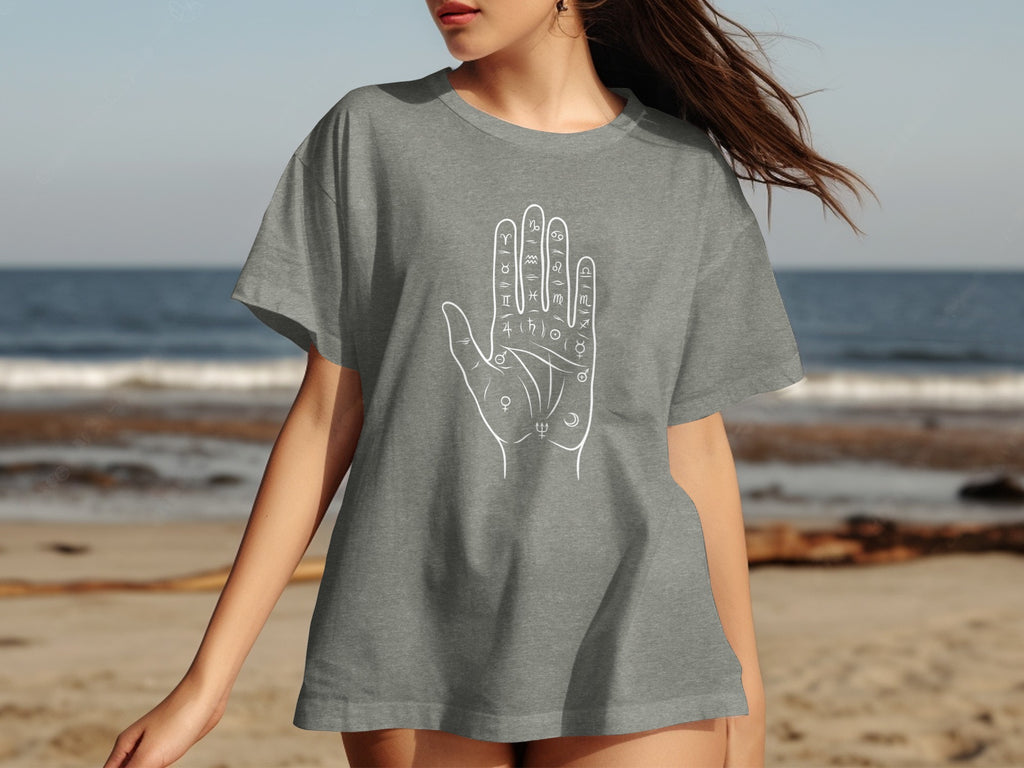 Gray t-shirt with a white outline of a hand featuring astrological symbols.