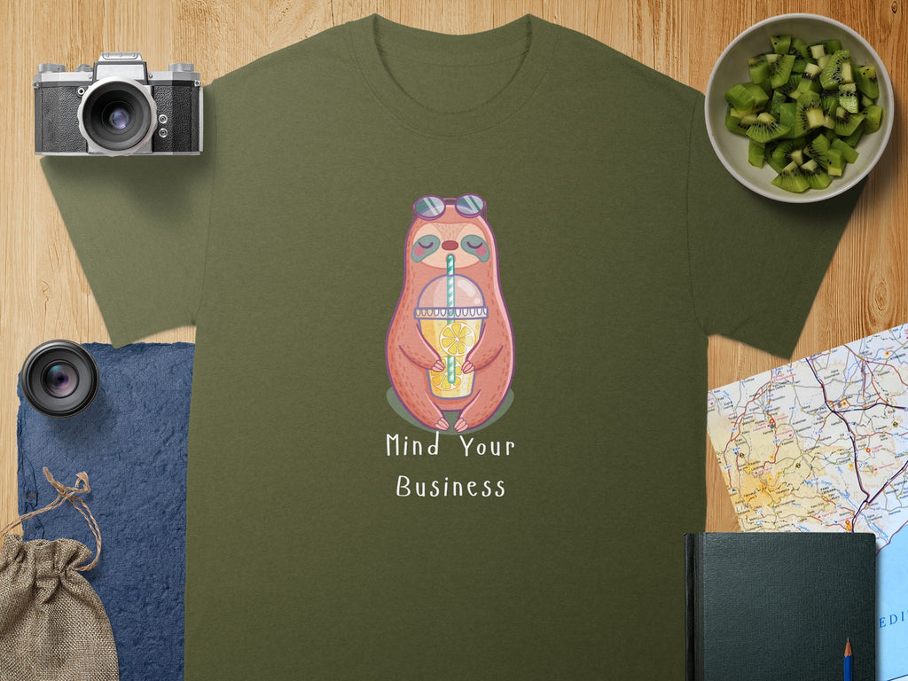 Green t-shirt with a cartoon sloth drinking from a cup and text "Mind Your Business".
