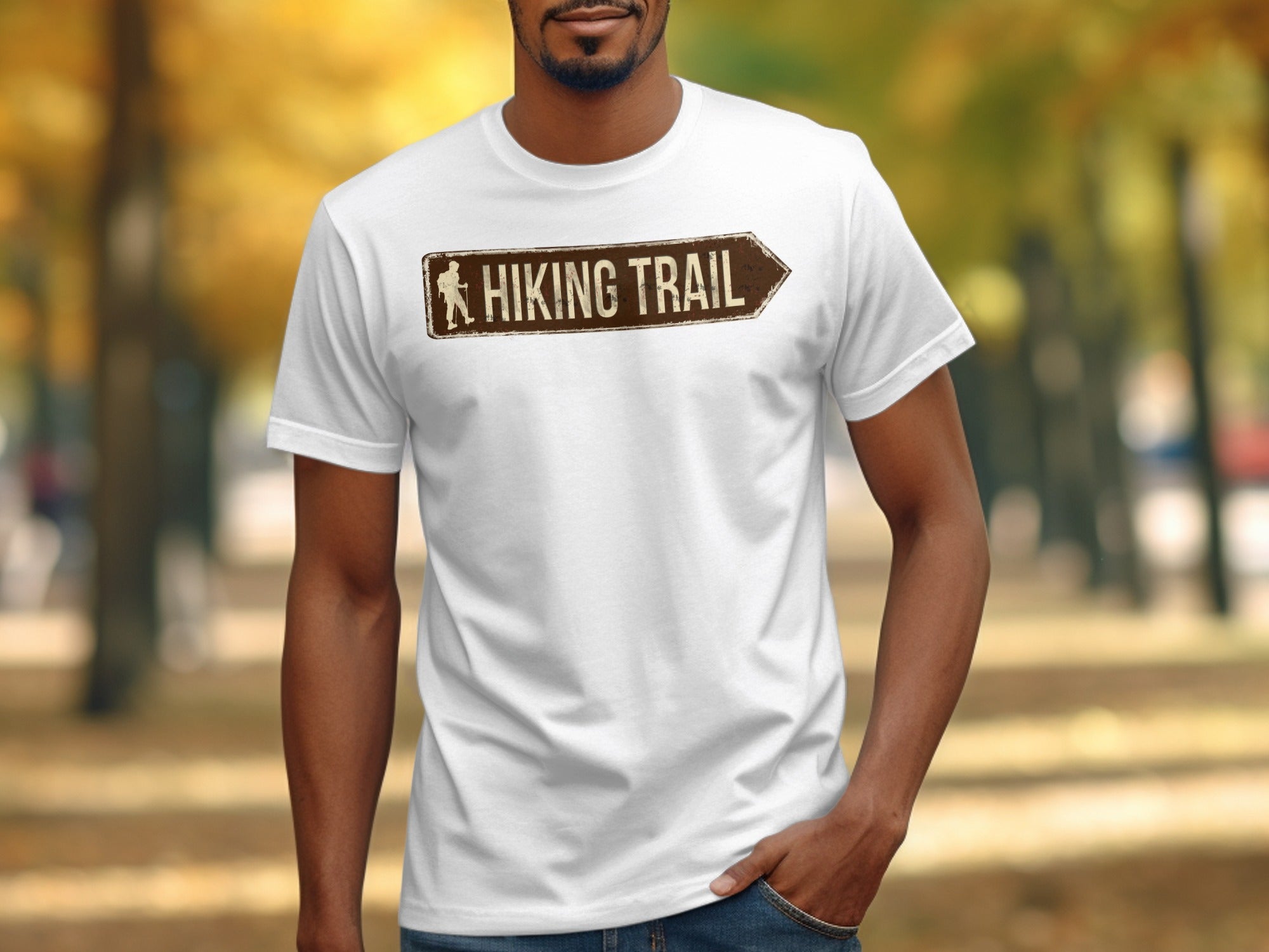 White t-shirt with brown "Hiking Trail" sign graphic and hiker silhouette.