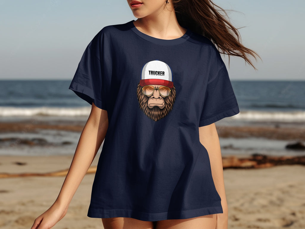Dark blue t-shirt with Bigfoot wearing a trucker hat and sunglasses graphic.