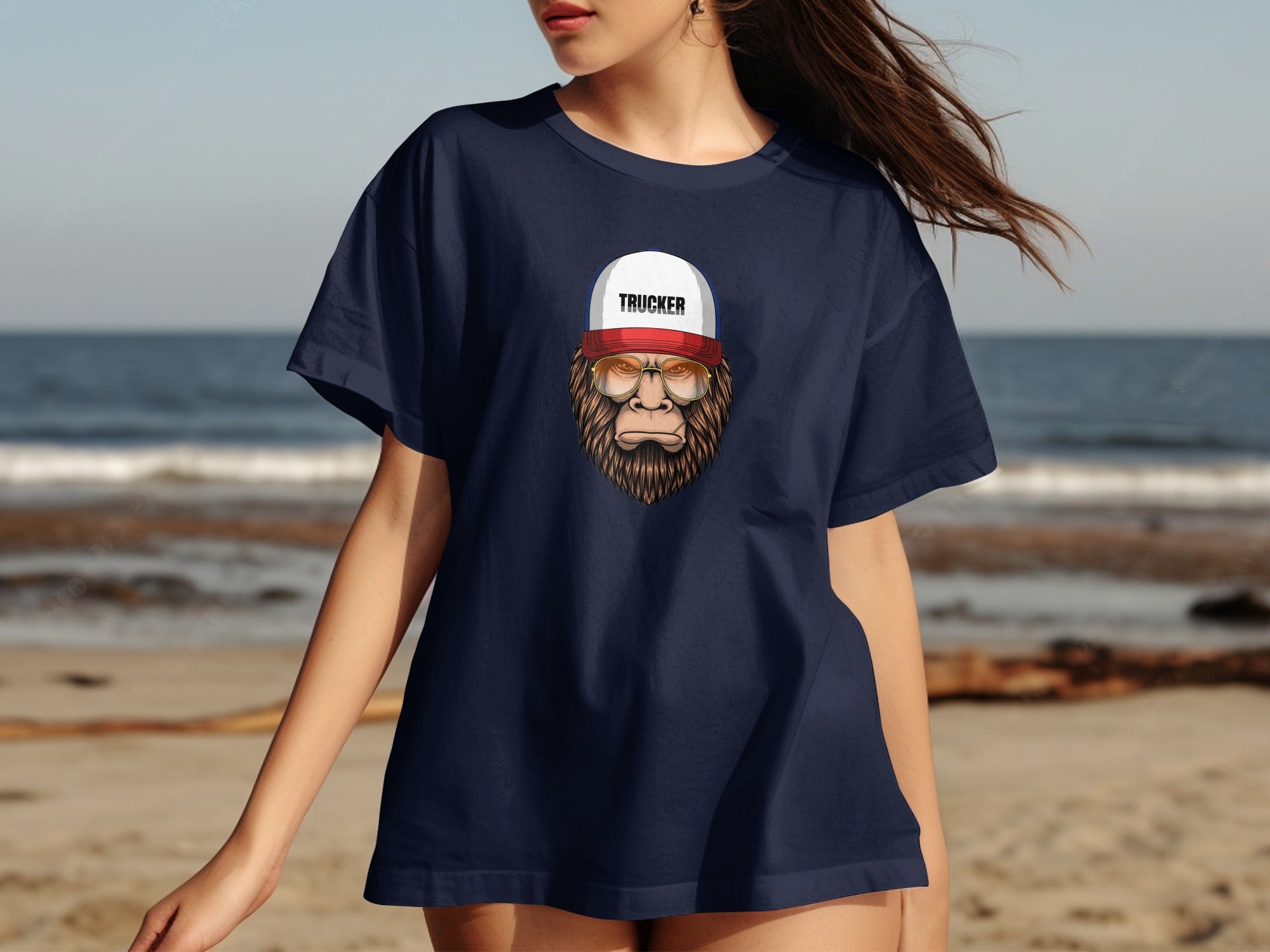 Dark blue t-shirt with Bigfoot wearing a trucker hat and sunglasses graphic.
