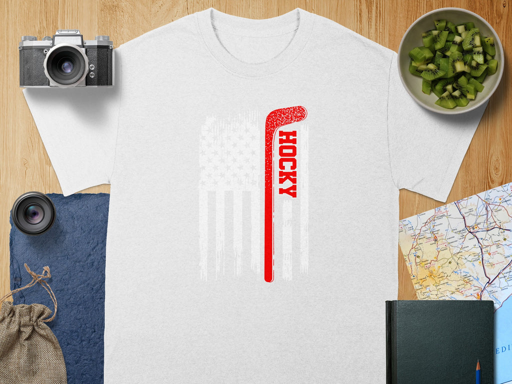 White t-shirt with red hockey stick over distressed American flag graphic.