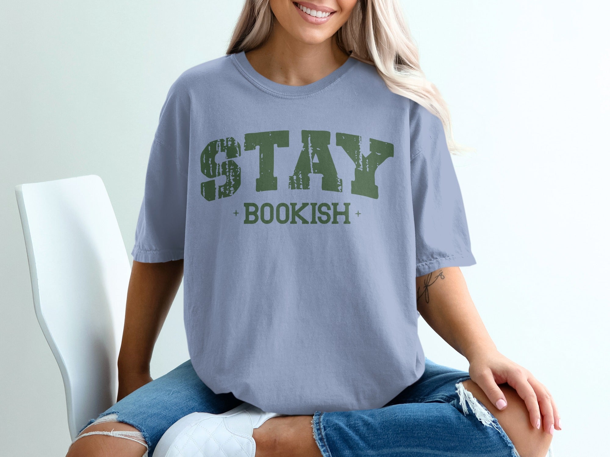 Light blue t-shirt with green distressed text that says "STAY BOOKISH".