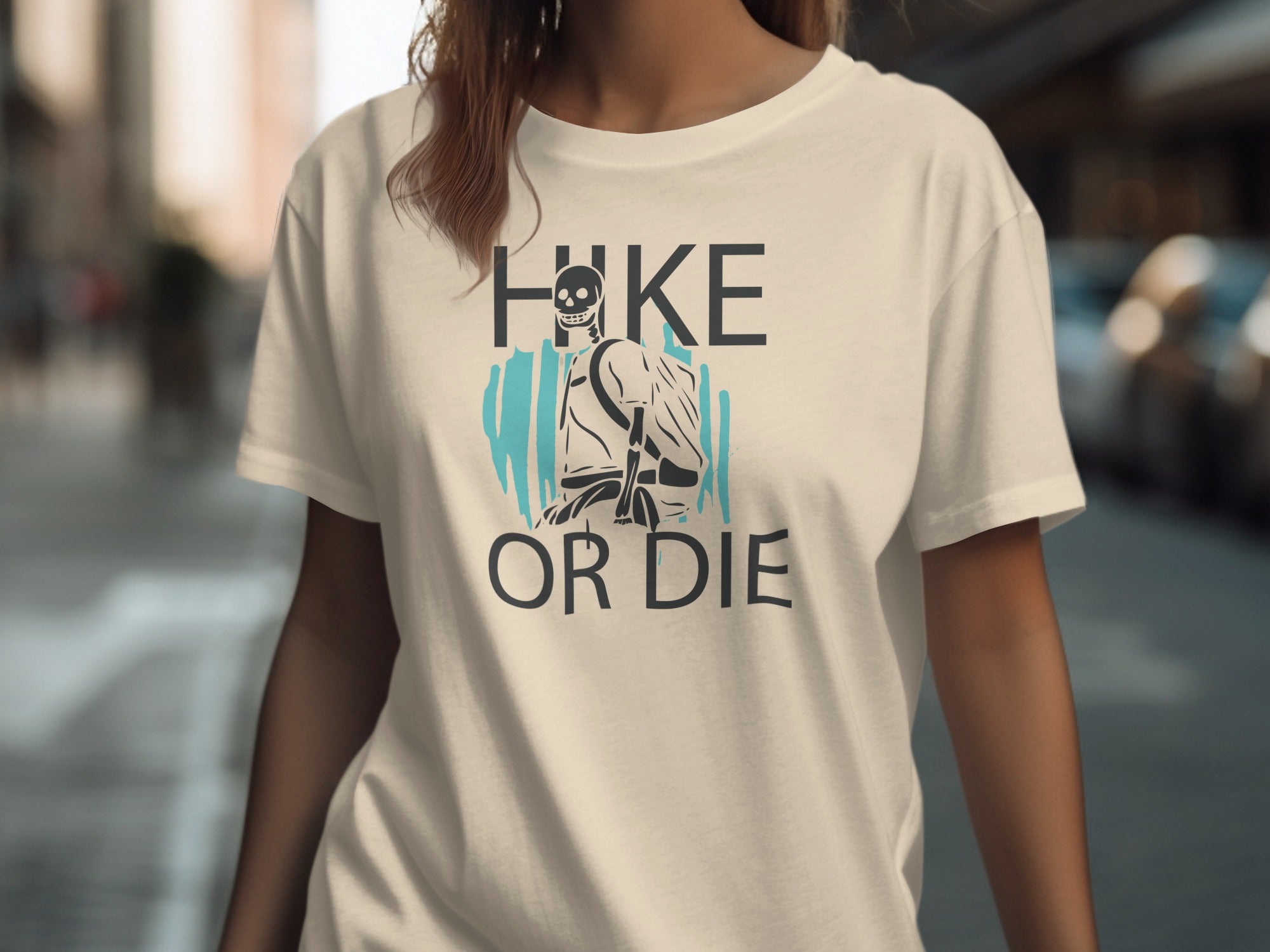 Cream t-shirt with graphic "HIKE OR DIE" featuring a skeleton hiker.