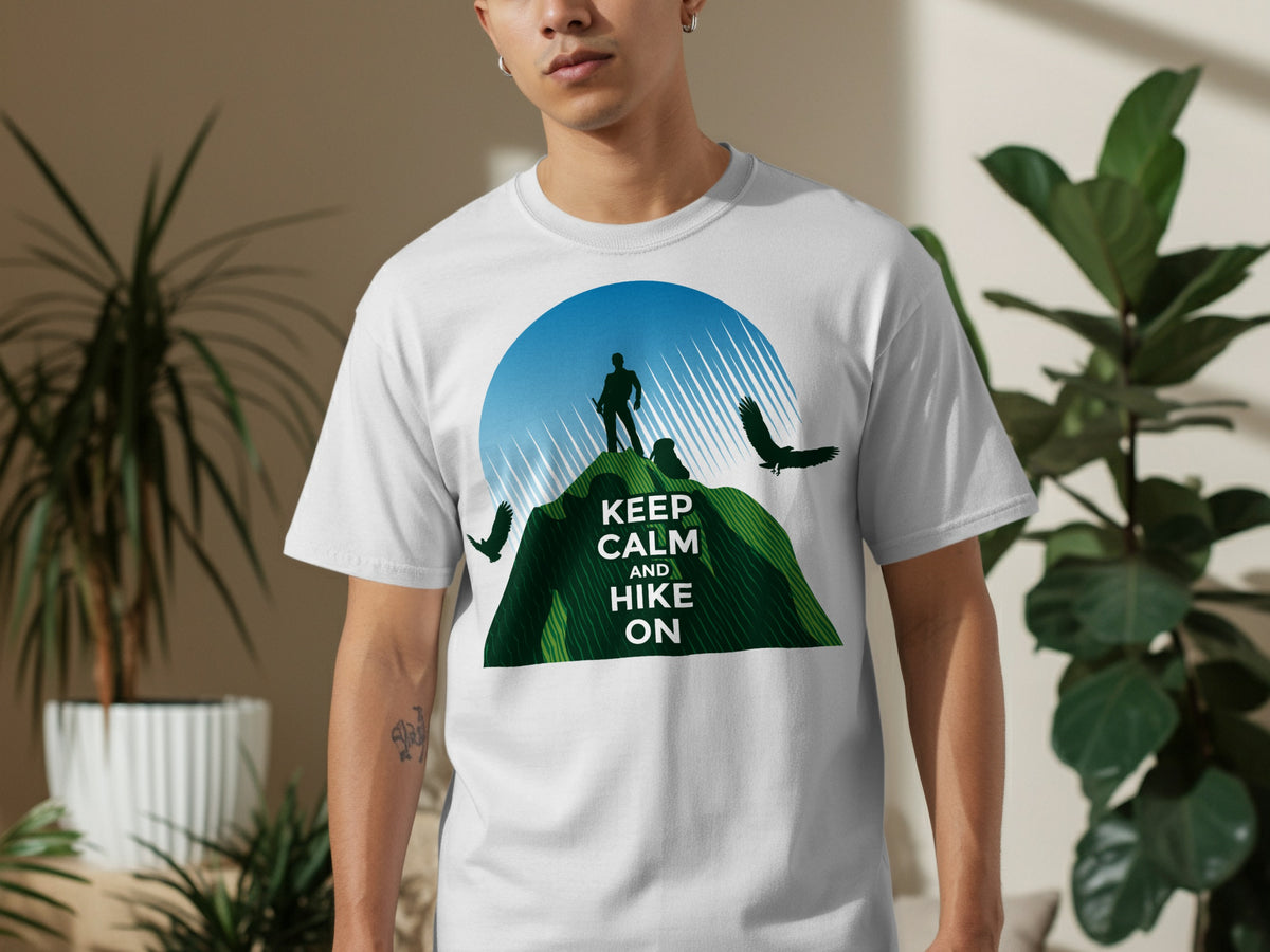 White t-shirt with graphic: hiker on mountain, birds, and text "KEEP CALM AND HIKE ON".