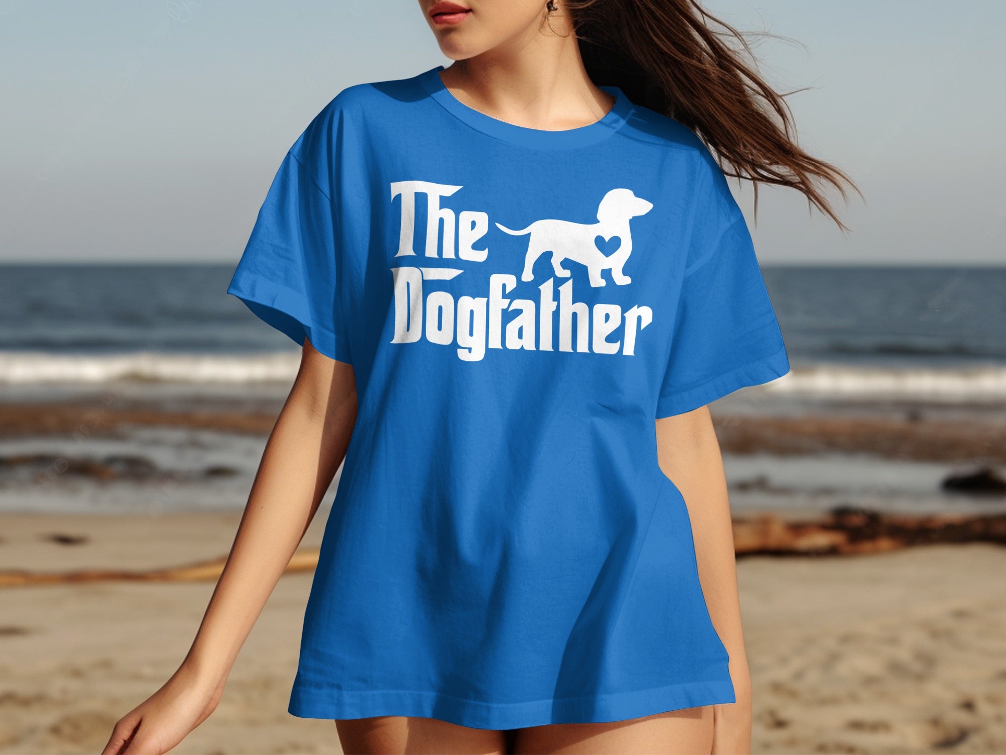 Blue t-shirt with white "The Dogfather" text and a dachshund silhouette with a heart.