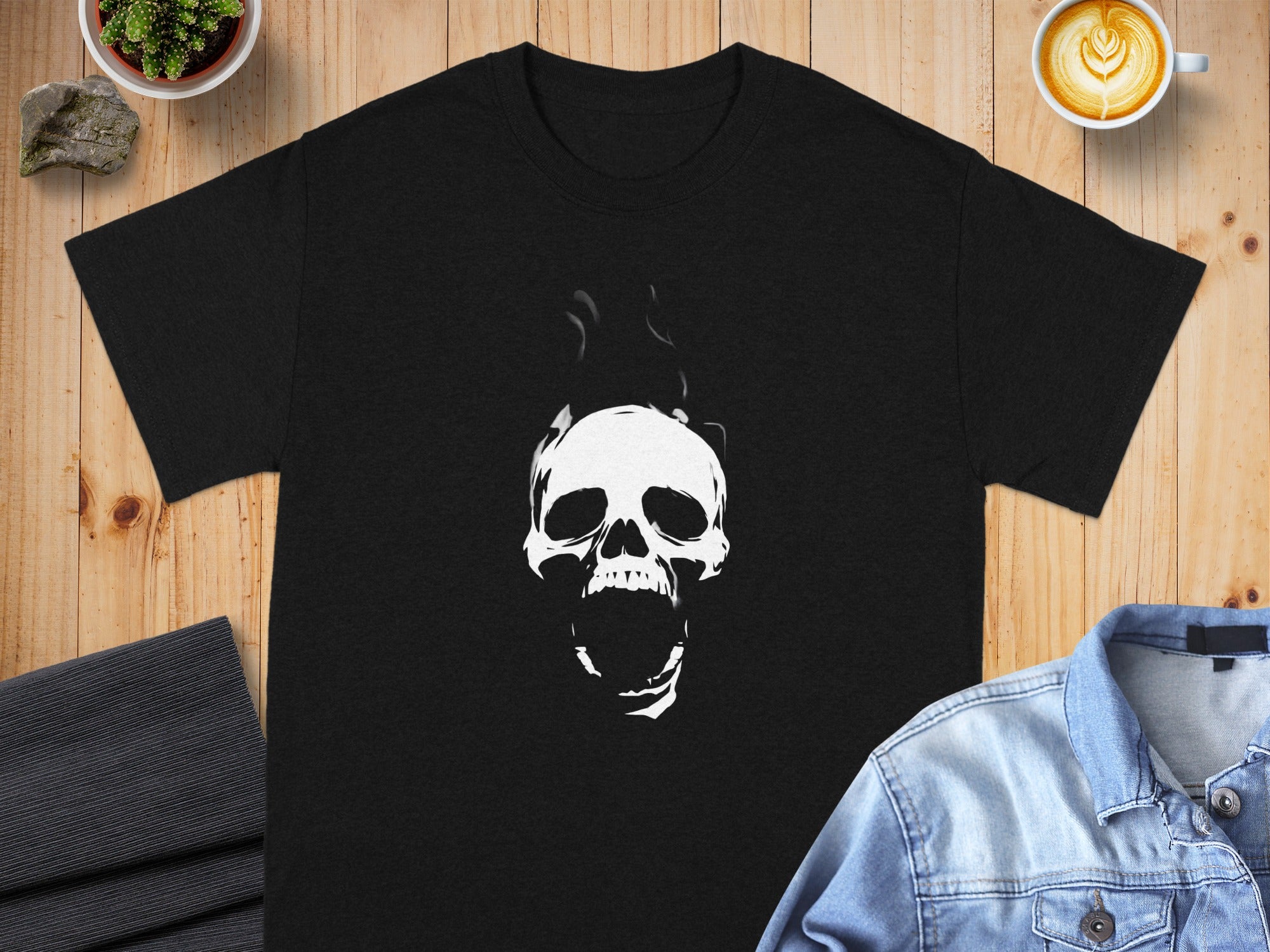 Black t-shirt with a white screaming skull design and smoke.