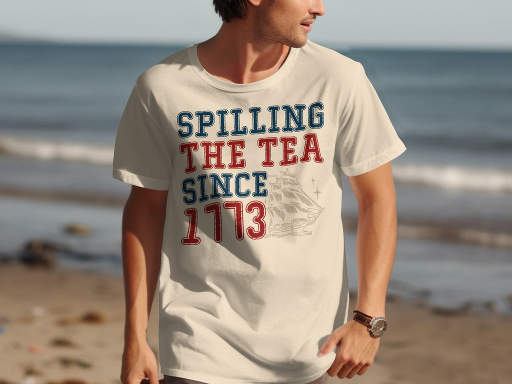 Cream t-shirt with "Spilling the Tea Since 1773" and sailing ship graphic.