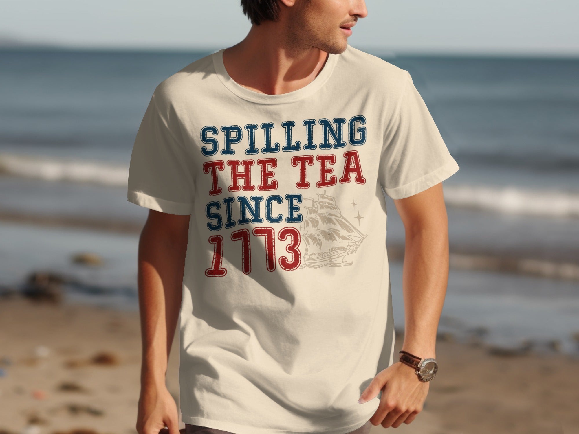 Cream t-shirt with "Spilling the Tea Since 1773" and sailing ship graphic.