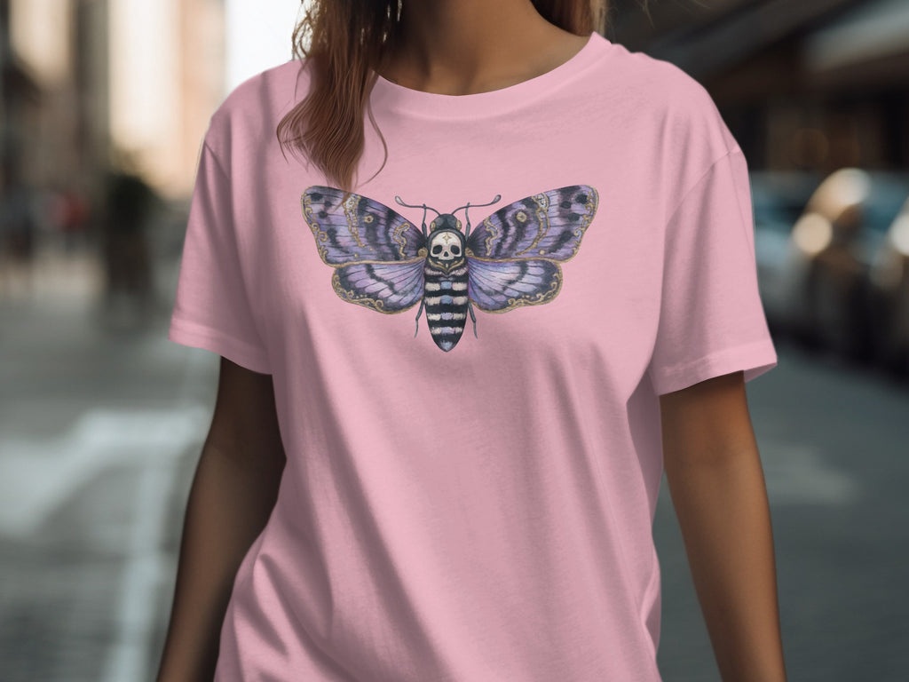 Pink t-shirt with a purple and black moth having a skull face printed on it.