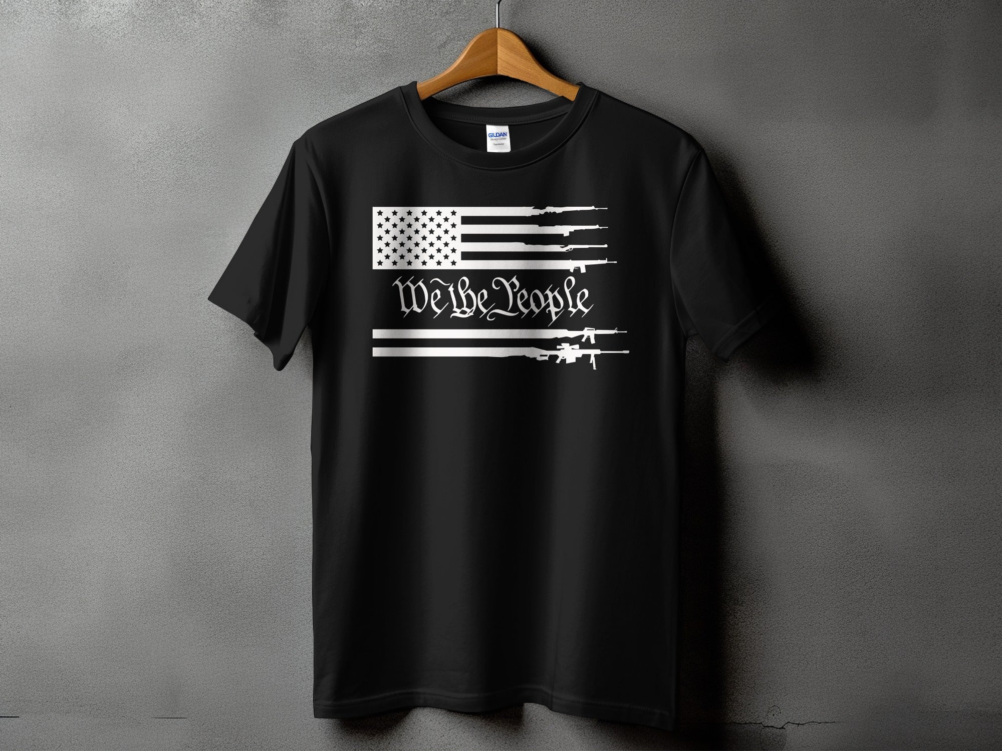 Black t-shirt with US flag design featuring rifles and "We the People" text.
