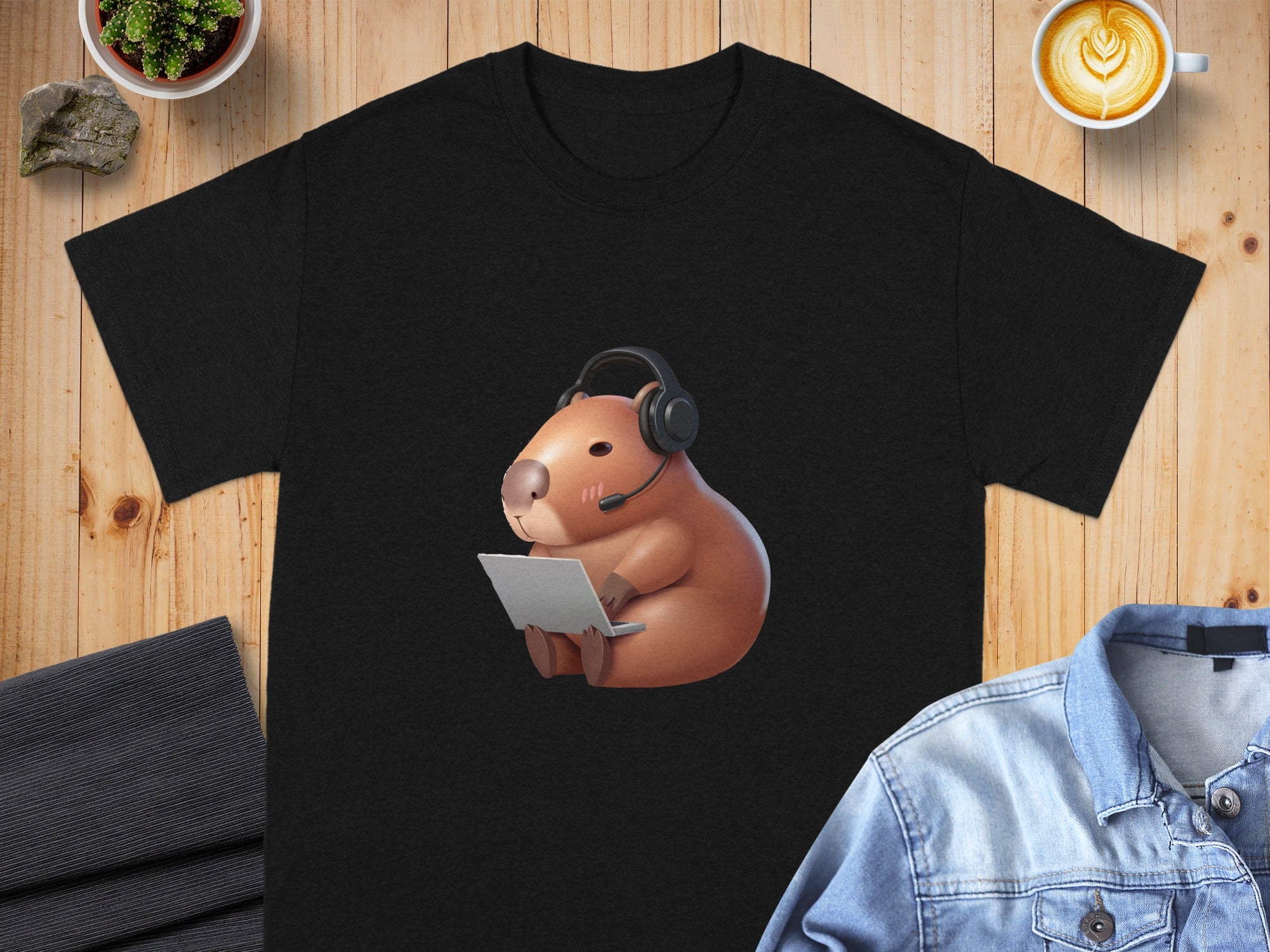 Black t-shirt with a capybara wearing headphones and using a laptop.