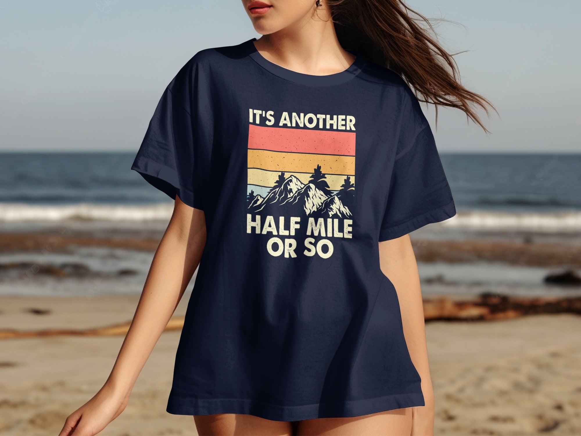 Navy t-shirt with mountains and text: "IT'S ANOTHER HALF MILE OR SO".