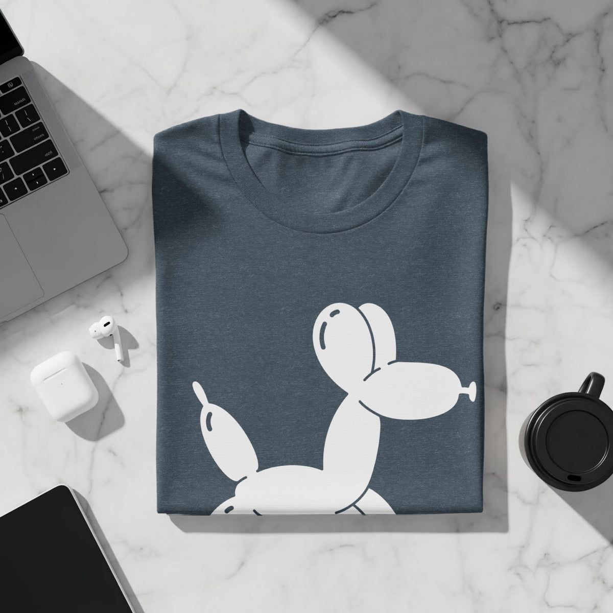 Dark blue t-shirt folded with a white balloon dog graphic.