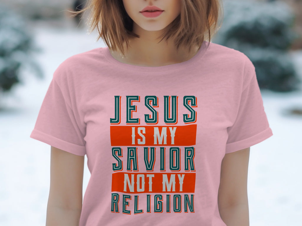 Pink t-shirt with "JESUS IS MY SAVIOR NOT MY RELIGION" text.