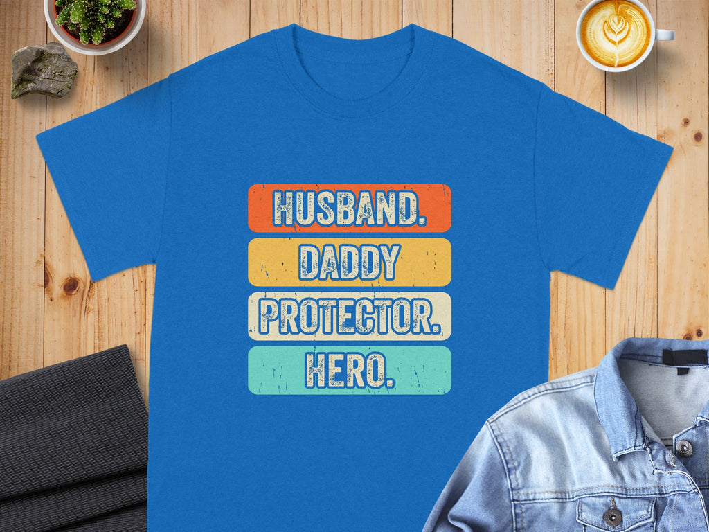 Blue t-shirt with "Husband. Daddy. Protector. Hero." text in retro font.