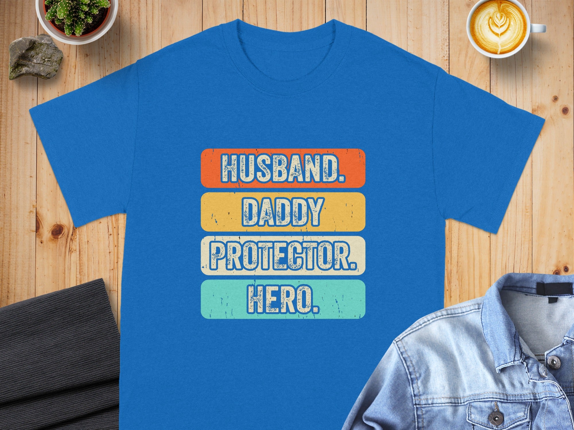 Blue t-shirt with "Husband. Daddy. Protector. Hero." text in retro font.