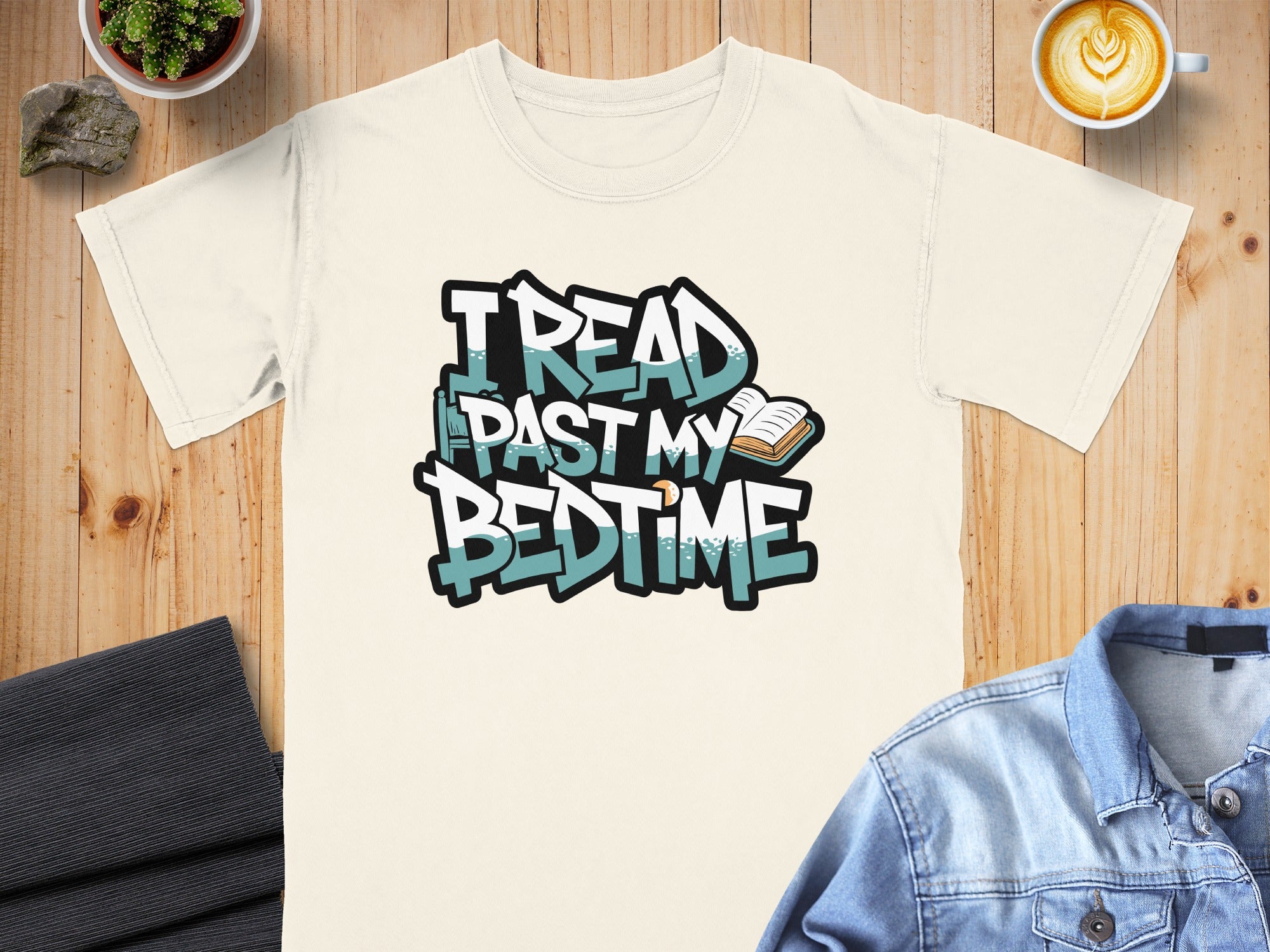 Cream t-shirt with "I READ PAST MY BEDTIME" graffiti-style text and an open book.