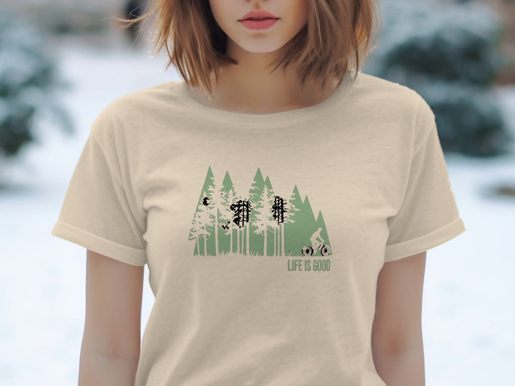 Light tan t-shirt with a forest and mountain bike graphic, "LIFE IS GOOD" text.