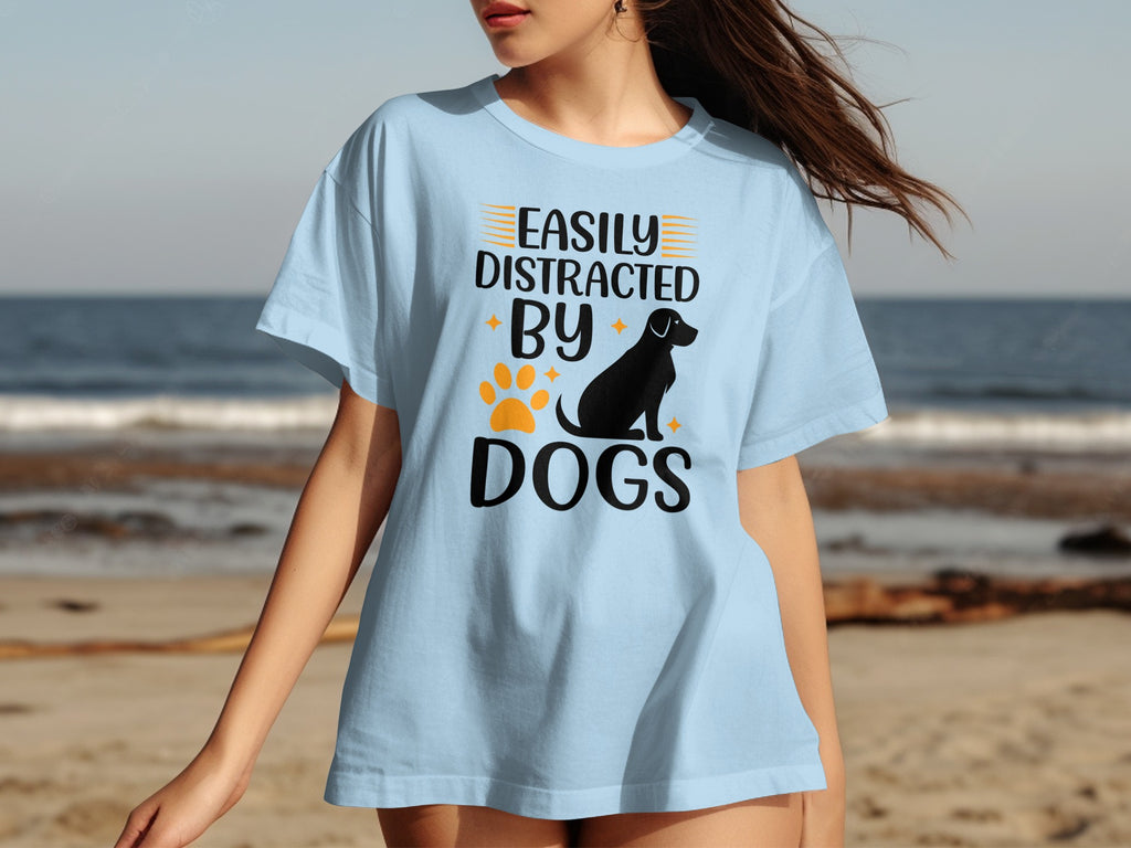 Light blue t-shirt with text "EASILY DISTRACTED BY DOGS" and dog silhouette.