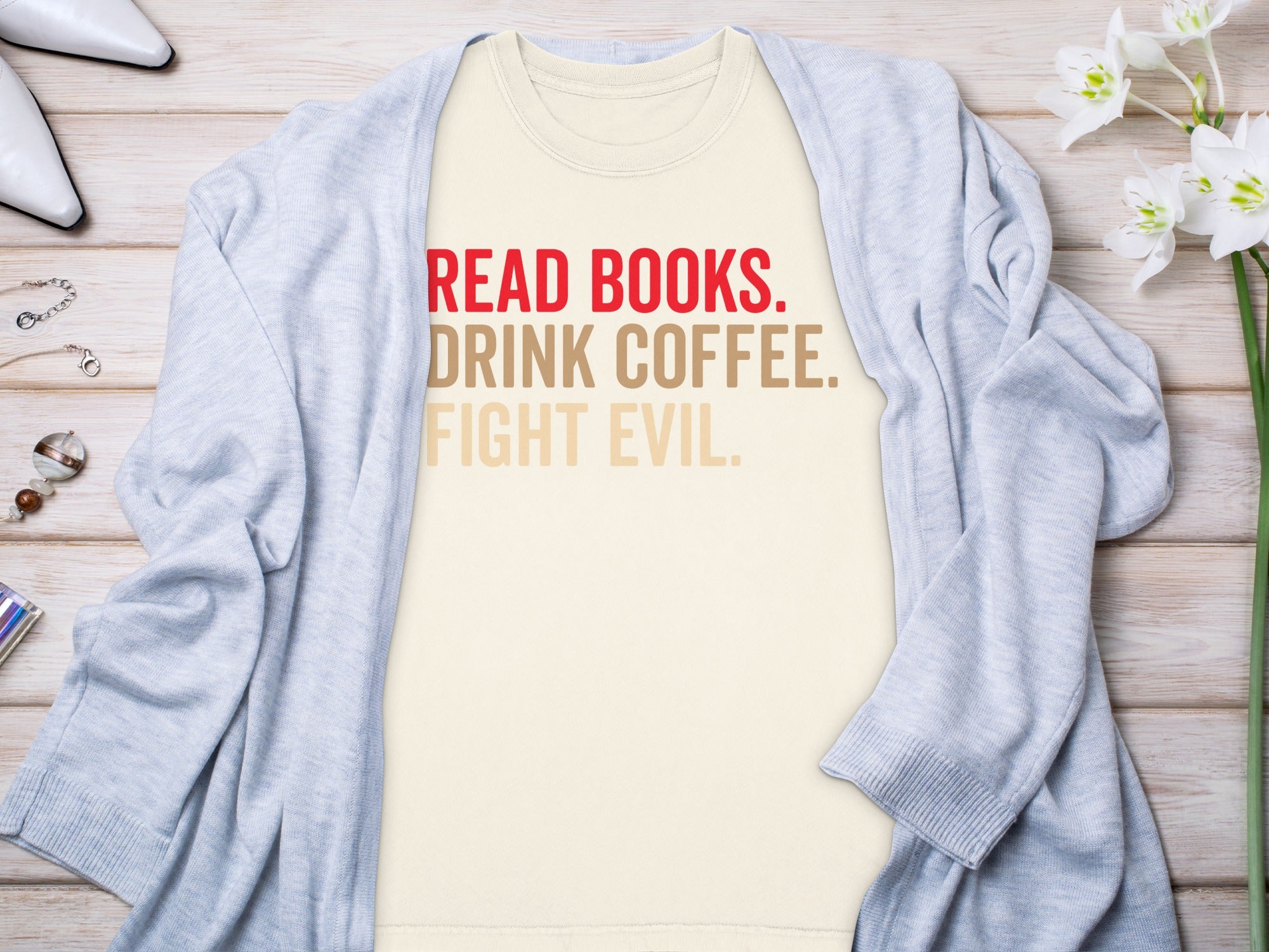 Cream t-shirt with "READ BOOKS. DRINK COFFEE. FIGHT EVIL." text.