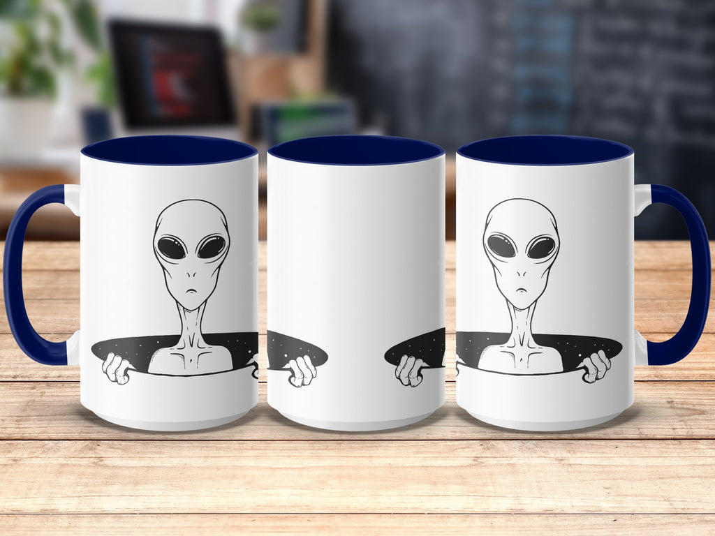 White mugs with blue handles, featuring a black and white alien design.