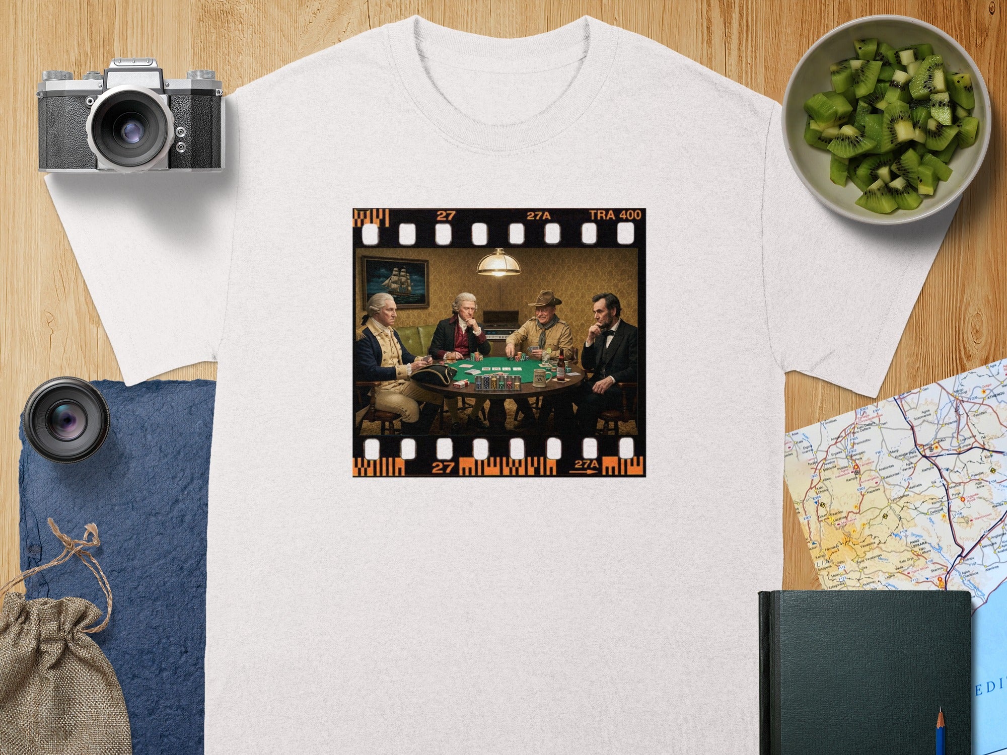 Four historical figures play poker in a film strip across a white t-shirt.