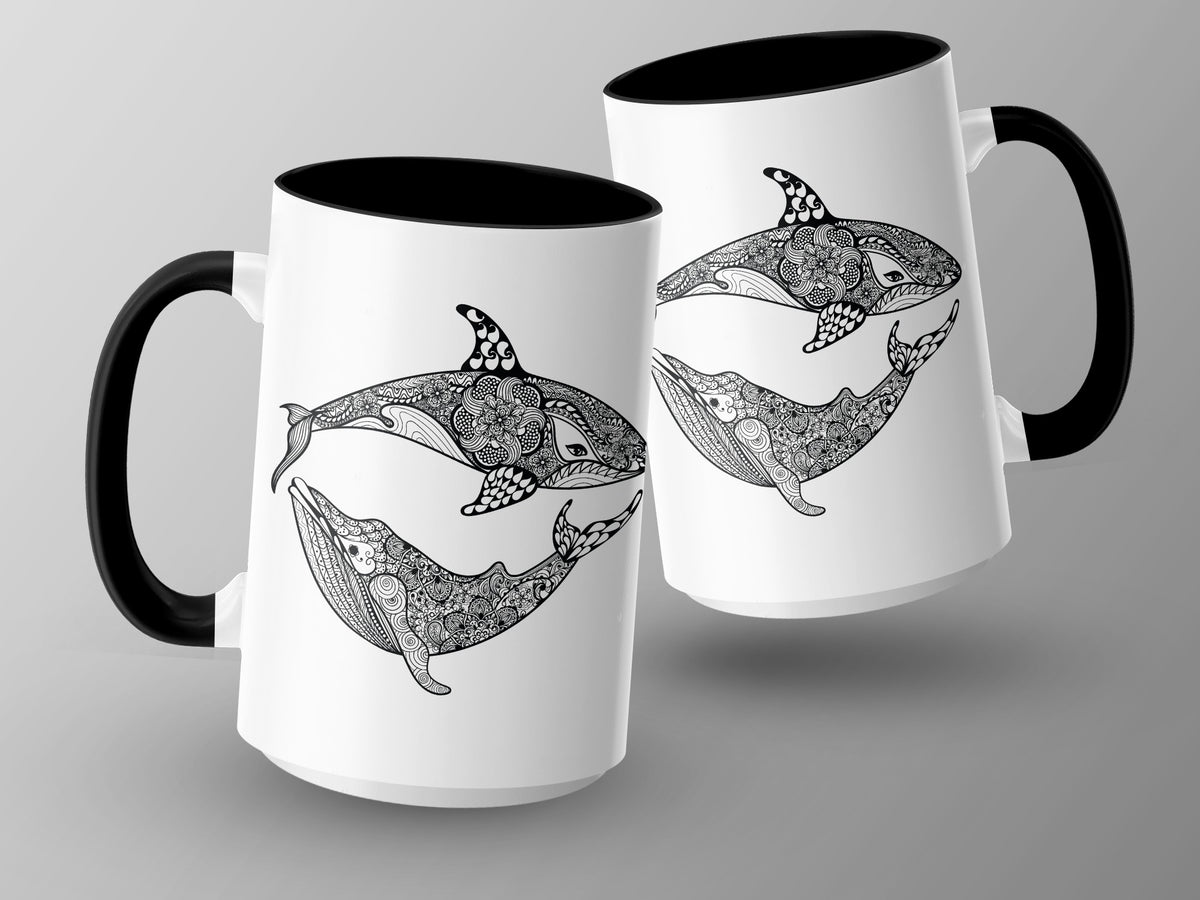 Two white mugs with black handles feature intricate black and white whale and orca designs.
