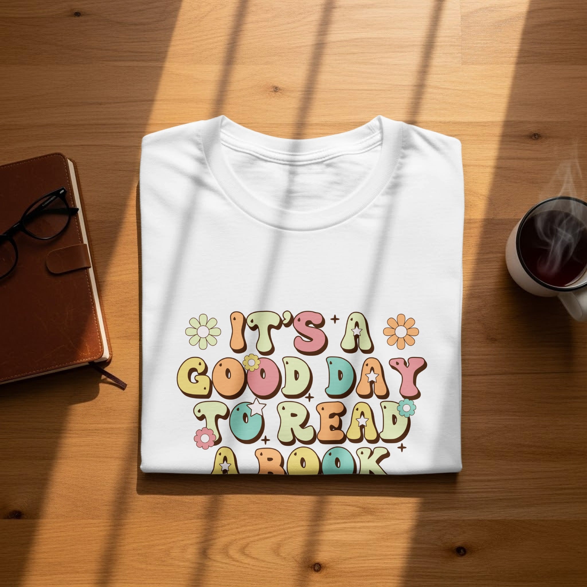 White t-shirt with "It's a good day to read a book" text.